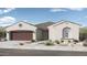 Charming single-story home featuring desert landscaping, a two-car garage, and neutral color palette at 14315 W Calle Lejos Rd, Surprise, AZ 85387