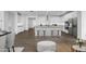 Bright kitchen featuring stainless steel appliances, a kitchen island with barstool seating and white cabinets at 14315 W Calle Lejos Rd, Surprise, AZ 85387