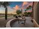 Gorgeous back patio overlooking golf course with desert landscaping, mature palms, and sunset views at 15131 W Daybreak Dr, Surprise, AZ 85374