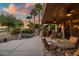 Relaxing back patio featuring an outdoor kitchen, seating area, and desert landscaping overlooking the golf course at 15131 W Daybreak Dr, Surprise, AZ 85374