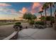 Beautiful back patio at sunset with mature landscaping and relaxing water feature with golf course view at 15131 W Daybreak Dr, Surprise, AZ 85374