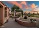 Desert landscaped backyard and sunset views with cactus and curved walls at 15131 W Daybreak Dr, Surprise, AZ 85374