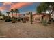 Desert landscaped backyard with covered patio and mature landscaping at 15131 W Daybreak Dr, Surprise, AZ 85374