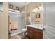 Well-lit bathroom with a shower and a vanity with double sinks, complemented by stylish decor at 15131 W Daybreak Dr, Surprise, AZ 85374