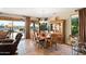 Elegant dining area with a chandelier, wood table, and large windows offering views of the backyard at 15131 W Daybreak Dr, Surprise, AZ 85374