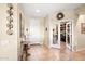 Inviting entryway with tile flooring, decorative accents, leading to a home office and main living areas at 15131 W Daybreak Dr, Surprise, AZ 85374