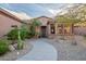 Inviting front entrance with stone accents, desert landscaping, and a winding walkway at 15131 W Daybreak Dr, Surprise, AZ 85374