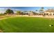 Scenic view of a lush golf course with well-maintained greens, trees, and blue sky, highlighting community amenities at 15131 W Daybreak Dr, Surprise, AZ 85374