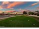 Well maintained golf course at sunset with colorful sky and luxury homes at 15131 W Daybreak Dr, Surprise, AZ 85374