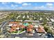 Expansive aerial view of a community featuring lush landscaping, swimming pool, and well-maintained buildings with terracotta roofs at 17077 N Zuni Trl, Surprise, AZ 85374