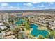 Expansive aerial view of the community showcasing the golf course, lakes, homes, and surrounding landscape at 17077 N Zuni Trl, Surprise, AZ 85374