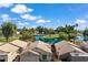 Aerial view showcasing a well-maintained home, lush landscaping, golf course, and serene lake views at 17077 N Zuni Trl, Surprise, AZ 85374