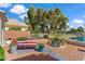 Relaxing backyard features desert landscaping, a lounge chair, and a beautiful lake view at 17077 N Zuni Trl, Surprise, AZ 85374