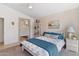 Comfortable bedroom features natural light from the window, carpeting and adjacent to the bathroom at 17077 N Zuni Trl, Surprise, AZ 85374