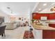 Bright kitchen featuring wooden cabinets, barstool seating, and an open floor plan that flows into the living area at 17077 N Zuni Trl, Surprise, AZ 85374