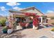 Charming patio with comfortable seating surrounded by colorful bougainvillea and lush greenery at 17077 N Zuni Trl, Surprise, AZ 85374