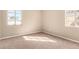 Bright bedroom featuring neutral carpet and two windows at 1736 E Coronado Rd, Phoenix, AZ 85006