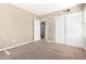 Bedroom with neutral carpet, closet, and ensuite bathroom at 1736 E Coronado Rd, Phoenix, AZ 85006