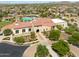 Beautiful aerial view of a community clubhouse with a pool, lush landscaping, and residential homes at 17496 W Summit Dr, Goodyear, AZ 85338