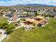 Aerial view of a community park featuring playground equipment, picnic shelters, and green spaces at 17496 W Summit Dr, Goodyear, AZ 85338