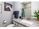 Well-lit bathroom features a granite countertop, a vanity, and a shower-tub combo at 17496 W Summit Dr, Goodyear, AZ 85338