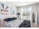 Cozy bedroom featuring a large window with natural light and decorative beach themed artwork at 17496 W Summit Dr, Goodyear, AZ 85338