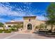 Beautiful clubhouse entrance featuring stone architecture, manicured landscaping, and a welcoming entrance at 17496 W Summit Dr, Goodyear, AZ 85338