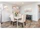 Elegant dining room with a stylish table, upholstered chairs, modern lighting, and decorative artwork at 17496 W Summit Dr, Goodyear, AZ 85338