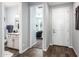 Inviting entryway showcasing wood-look tile flooring and views into the powder room and bedroom at 17496 W Summit Dr, Goodyear, AZ 85338