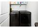 Laundry room with modern appliances and storage shelving at 17496 W Summit Dr, Goodyear, AZ 85338