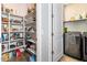 Walk-in pantry with ample shelving for storage adjacent to the laundry room at 17496 W Summit Dr, Goodyear, AZ 85338