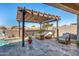 Charming covered patio featuring comfortable lounge seating around a fire pit, perfect for outdoor relaxation and entertaining at 17496 W Summit Dr, Goodyear, AZ 85338