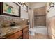 Elegant bathroom featuring granite countertops, a bathtub and stone accents at 18332 W Latham St, Goodyear, AZ 85338