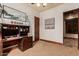 Comfortable carpeted bedroom featuring a desk and elegant trim and doors at 18332 W Latham St, Goodyear, AZ 85338