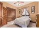 Relaxing bedroom features neutral walls, soft carpet and barn door closet at 18332 W Latham St, Goodyear, AZ 85338