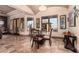 Stylish dining area featuring travertine floors, natural light, decorative chandelier, and seating at 18332 W Latham St, Goodyear, AZ 85338