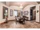 Cozy dining area featuring travertine floors, natural light, decorative chandelier, and comfortable seating at 18332 W Latham St, Goodyear, AZ 85338