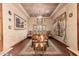 Formal dining room featuring hardwood floors, chandelier, decorative china cabinet, and elegant furnishings at 18332 W Latham St, Goodyear, AZ 85338