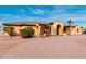 Charming one-story home featuring a paver driveway, tile roof, desert landscaping, and an arched entryway at 18332 W Latham St, Goodyear, AZ 85338