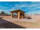 Outdoor gazebo with seating and grill, ideal for entertainment and enjoying the backyard scenery at 18332 W Latham St, Goodyear, AZ 85338