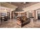 Open living space with elegant tile flooring, custom ceiling design, and seamless flow to the kitchen at 18332 W Latham St, Goodyear, AZ 85338