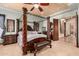 This main bedroom features a beautiful wood canopy bed and ensuite bath at 18332 W Latham St, Goodyear, AZ 85338