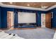 Theater room showcasing large screen and luxurious navy blue curtains for optimal viewing at 18332 W Latham St, Goodyear, AZ 85338