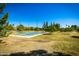 Outdoor basketball court surrounded by lush greenery and trees, providing a scenic recreational area at 1938 E Myrna Ln, Tempe, AZ 85284