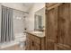 Bathroom features a tub, shower, and a granite vanity, complete with wood cabinets for stylish storage at 1938 E Myrna Ln, Tempe, AZ 85284