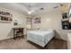 This bedroom features a ceiling fan, a bed, a window, and two shelves for storage and decoration at 1938 E Myrna Ln, Tempe, AZ 85284