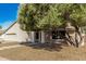 Inviting single-story home featuring desert landscaping, a stucco facade, and a two-car garage on a sunny day at 1938 E Myrna Ln, Tempe, AZ 85284