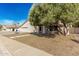 Inviting single-story home with desert landscaping, a stucco facade, and a two-car garage on a sunny day at 1938 E Myrna Ln, Tempe, AZ 85284