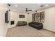 Comfortable living area with fireplace, neutral carpet, a modern ceiling fan and natural lighting at 1938 E Myrna Ln, Tempe, AZ 85284