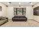 Bright living room with neutral carpet, large window, and stylish gray and green sofas at 1938 E Myrna Ln, Tempe, AZ 85284